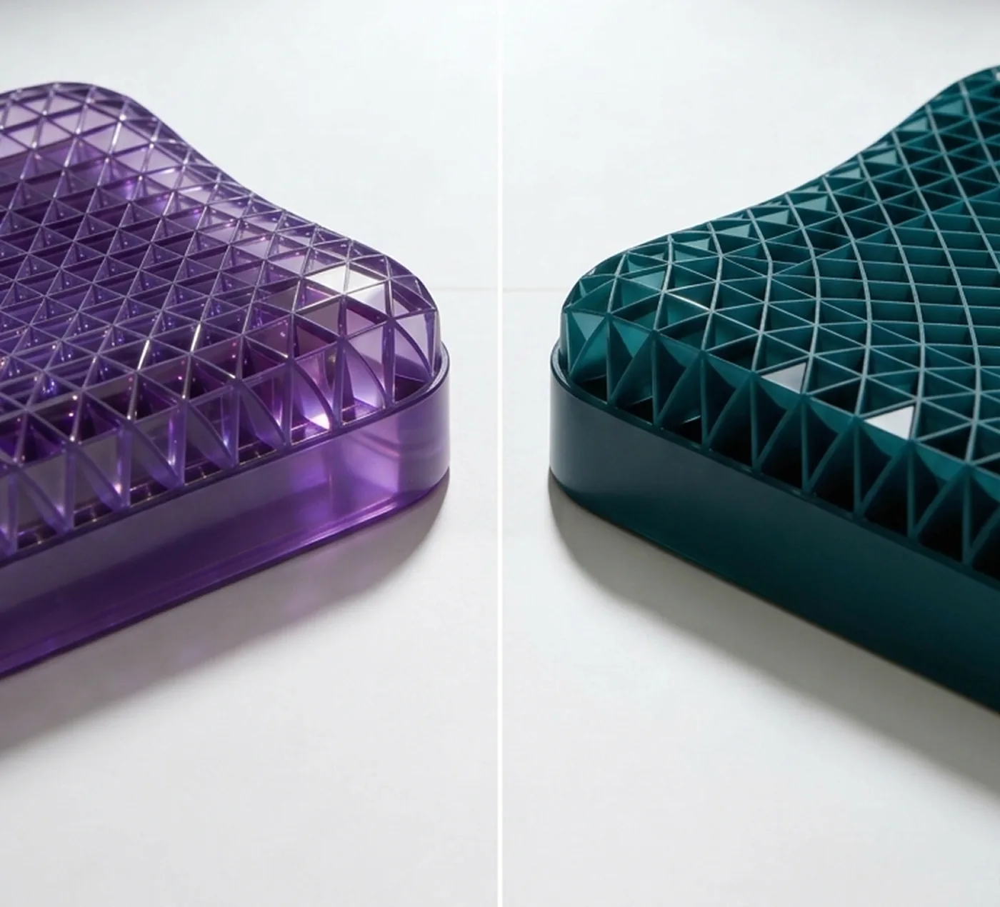 The Purple Pillow (left, translucent purple hex grid) and the Onyx AeroMatrix Pillow (right, opaque teal triangulated grid) shown side by side at the same angle.